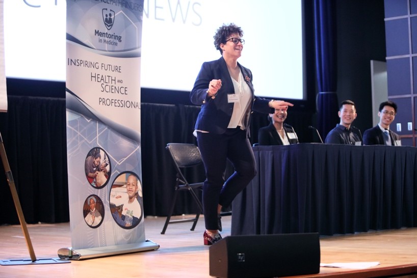 2019: Dr. Carla Easter of the National Human Genome Research Institute, one of four panelists, performs a Zumba move for the audience.