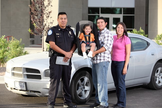 : A group of people standing in front of a car