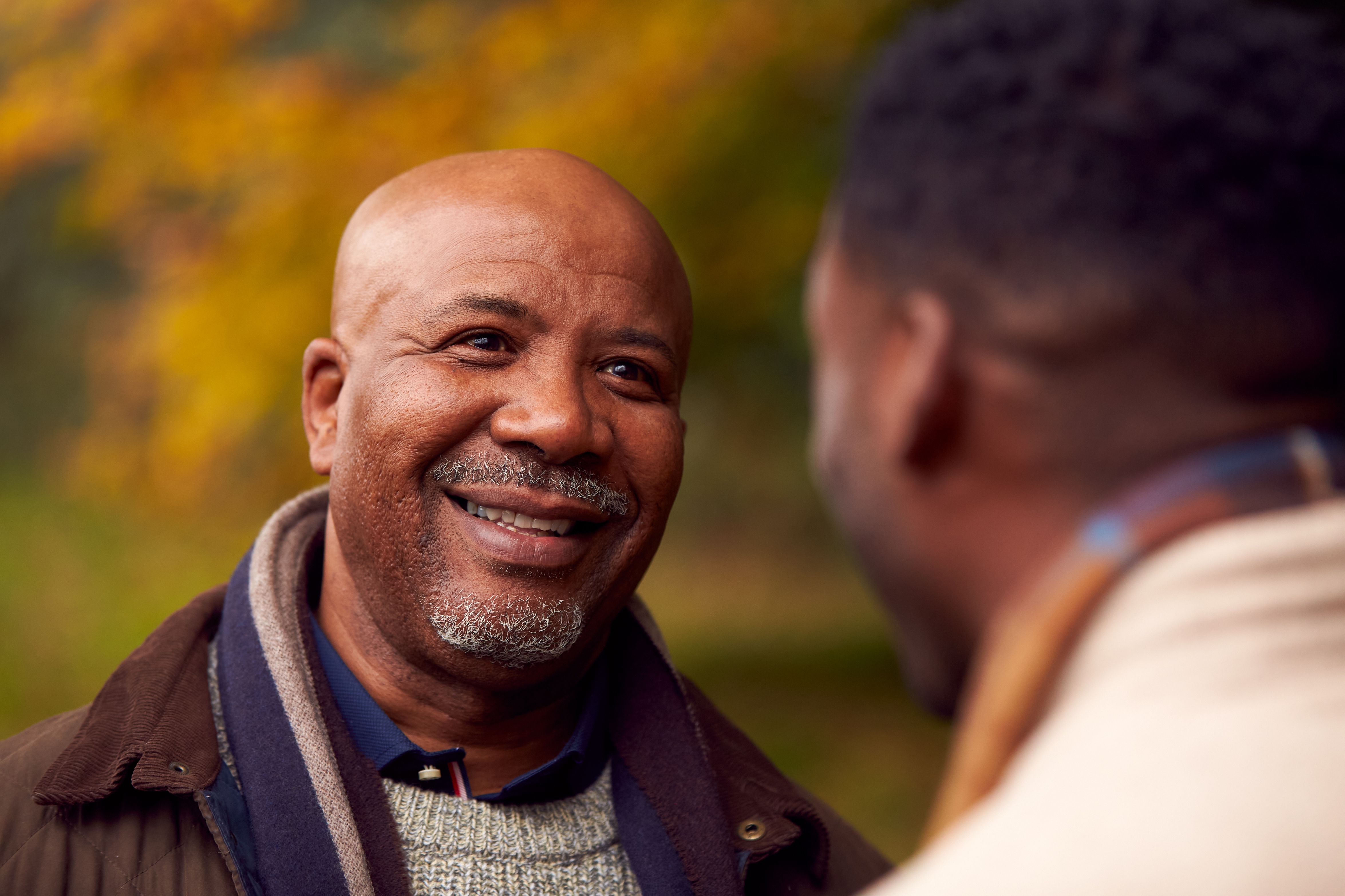 African American father talking with adult son