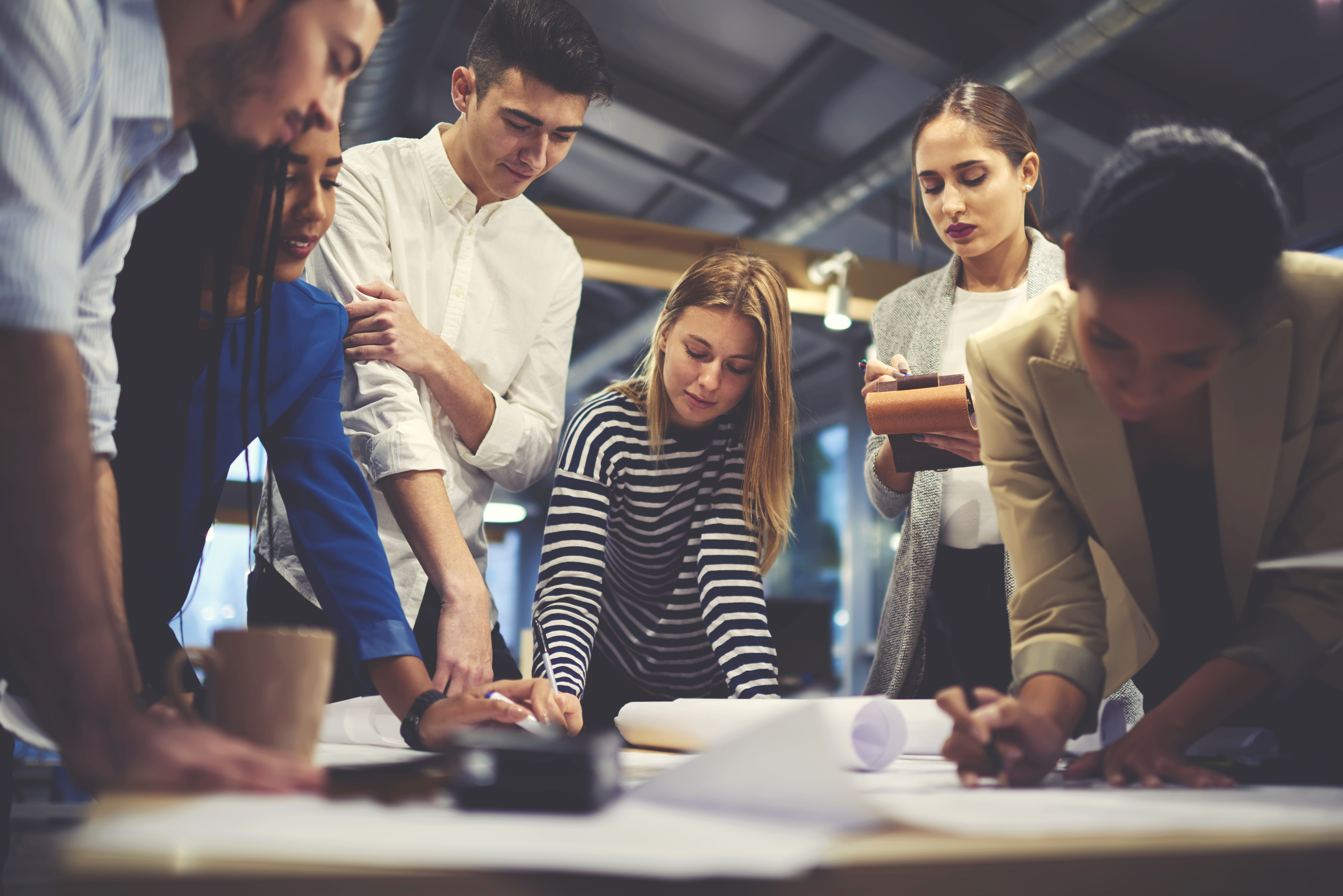 Group of people working together around a table.