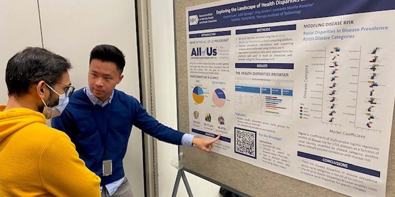 NIMHD postbac Vincent Lam explains the U.S. health disparities browser he developed to an attendee at the 2023 Postbac Poster Day
